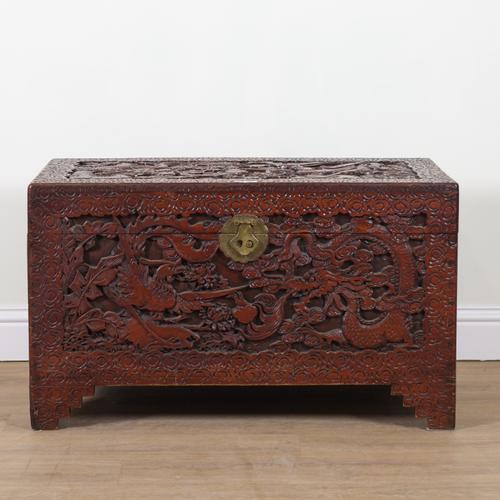 AN EARLY 20TH CENTURY EASTERN EXPORT EXTENSIVELY CARVED CAMPHOR WOOD TRUNK