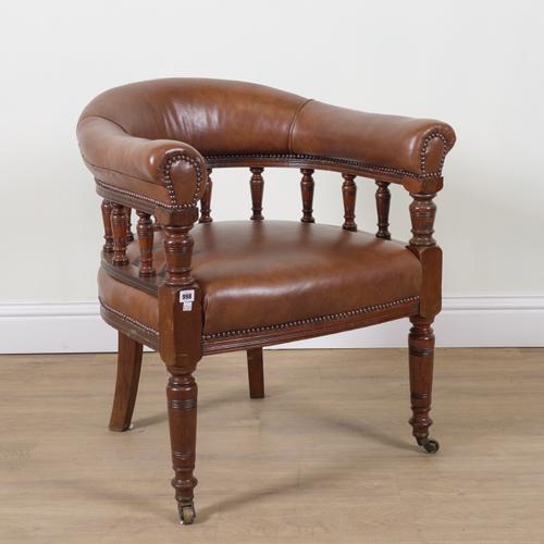 A VICTORIAN OAK FRAMED STUDDED TAN LEATHER UPHOLSTERED TUB BACK DESK CHAIR