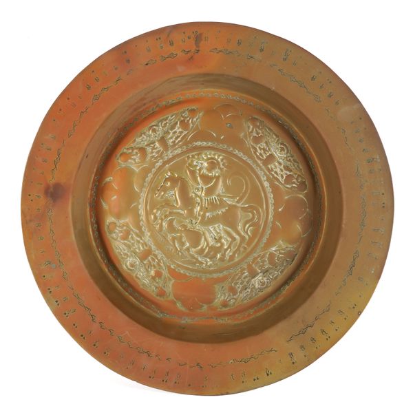 A BRASS 16TH CENTURY STYLE ‘NUREMBERG’ REPOUSSE ALMS DISH