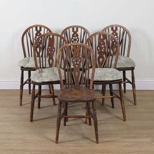 A SET OF SIX ASH AND ELM WHEELBACK DINING CHAIRS (6)