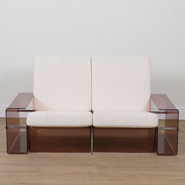 POSSIBLY MICHEL DUMAS; A SMOKED PERSPEX AND CHROME TUBULAR FRAMED TWO SEAT SOFA