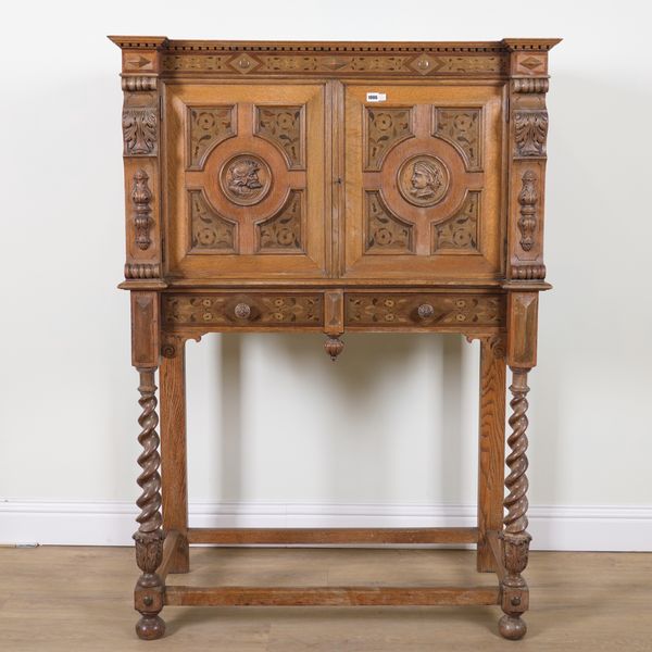 A 19TH CENTURY CARVED AND INLAID OAK CABINET