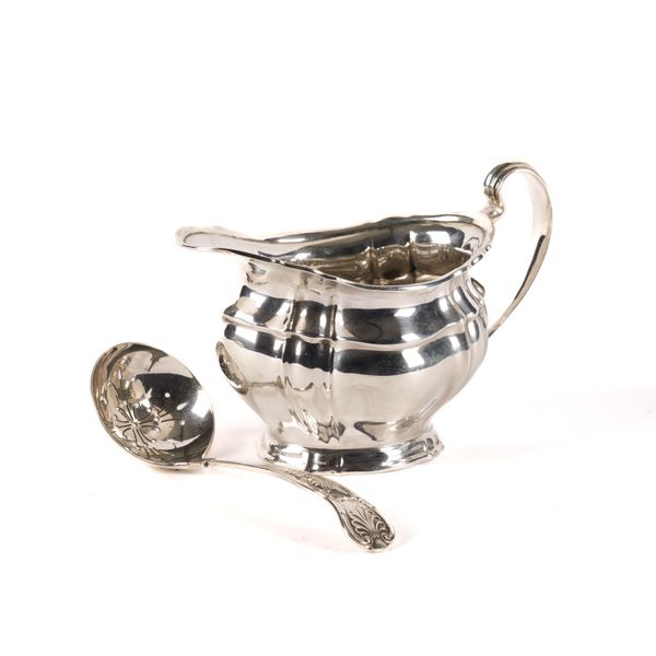 A SILVER MILK JUG AND A SILVER SUGAR SIFTING SPOON (2)