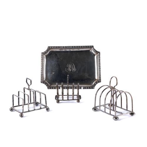 A CONTINENTAL CARD TRAY AND THREE SILVER FIVE BAR TOASTRACKS (4)