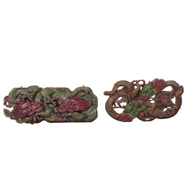 A PAIR OF SOUTH EAST ASIAN POLYCHROME PAINTED AND CARVED HARDWOOD PANELS (2)