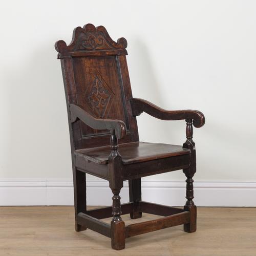 A 17TH CENTURY AND LATER OAK WAINSCOT OPEN ARMCHAIR