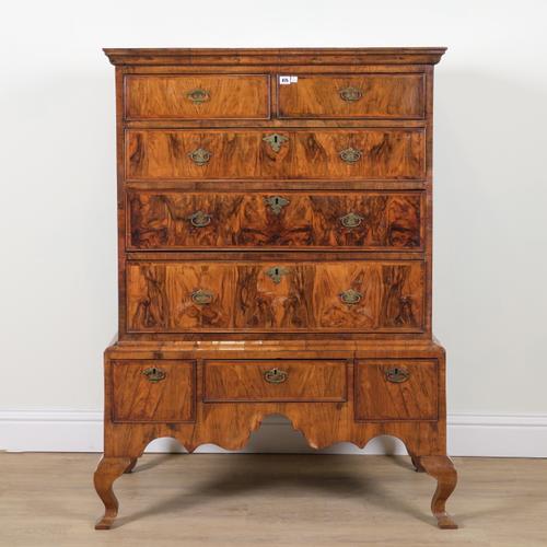 A GEORGE I FEATHER BANDED WALNUT CHEST ON STAND