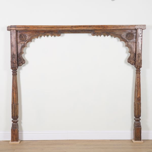 A 19TH CENTURY INDIAN CARVED HARDWOOD DOOR SURROUND