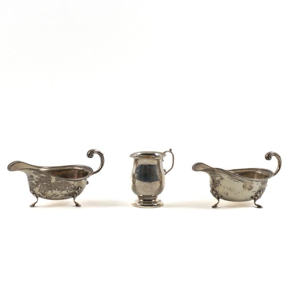 A PAIR OF SILVER SAUCEBOATS AND A SILVER CHRISTENING MUG (3)
