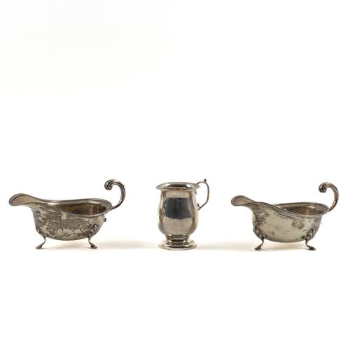 A PAIR OF SILVER SAUCEBOATS AND A SILVER CHRISTENING MUG (3)