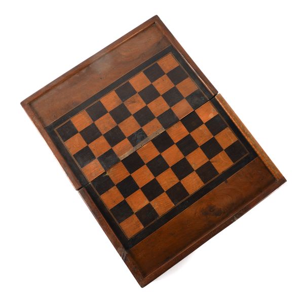 A CONTINENTAL WALNUT AND FRUITWOOD GAMES BOARD WITH COUNTERS AND LEATHER SHAKERS
