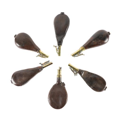 A GROUP OF LEATHER AND BRASS MOUNTED SHOT FLASKS (6)