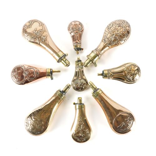 A GROUP OF NINE BRASS AND COPPER GUN POWDER FLASKS