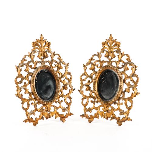 A PAIR OF GILT-METAL ROCOCO REVIVAL CARTOUCHE SHAPED MANTEL FRAMES (2)