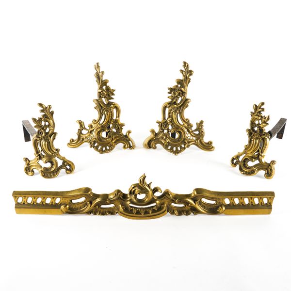 A VICTORIAN GILT LACQUERED BRASS ROCOCO REVIVAL ADJUSTABLE FENDER AND A PAIR OF CHENET