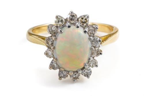 AN OPAL AND DIAMOND CLUSTER RING