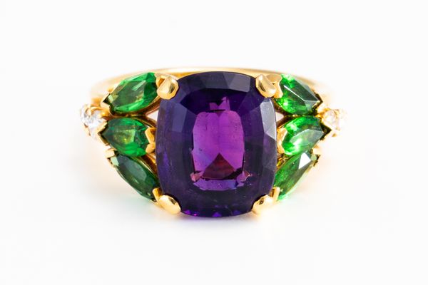 A GOLD, AMETHYST, DIAMOND AND GREEN GARNET SET RING