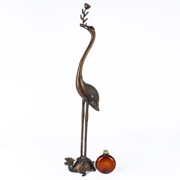 A JAPANESE PATINATED METAL `CRANE AND TURTLE' FORM CANDLESTICK (2)