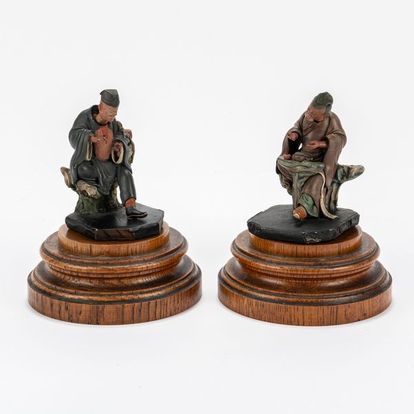 A PAIR OF CHINESE PAINTED CLAY NODDING HEAD FIGURES