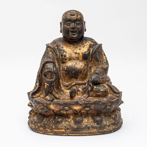 A CHINESE GILT-LACQUERED BRONZE FIGURE OF BUDAI