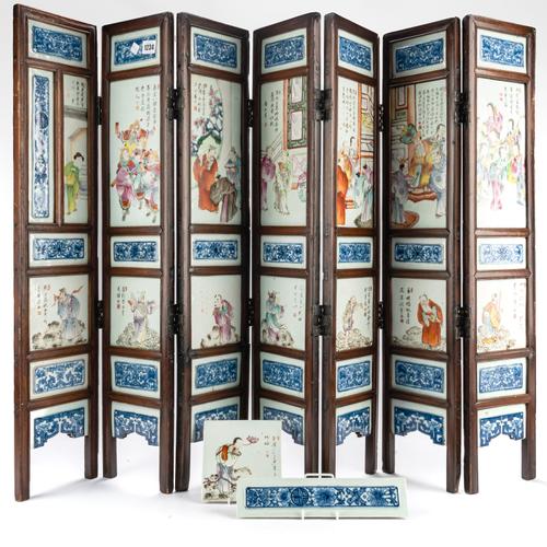 A CHINESE FAMILLE-ROSE PORCELAIN AND WOOD SEVEN PANEL SCREEN