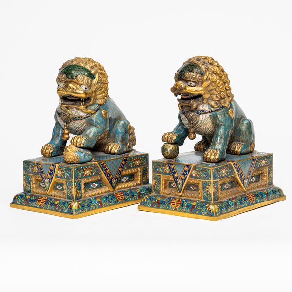 A PAIR OF CHINESE GILT-METAL AND CLOISONNE BUDDHIST LIONS (2)