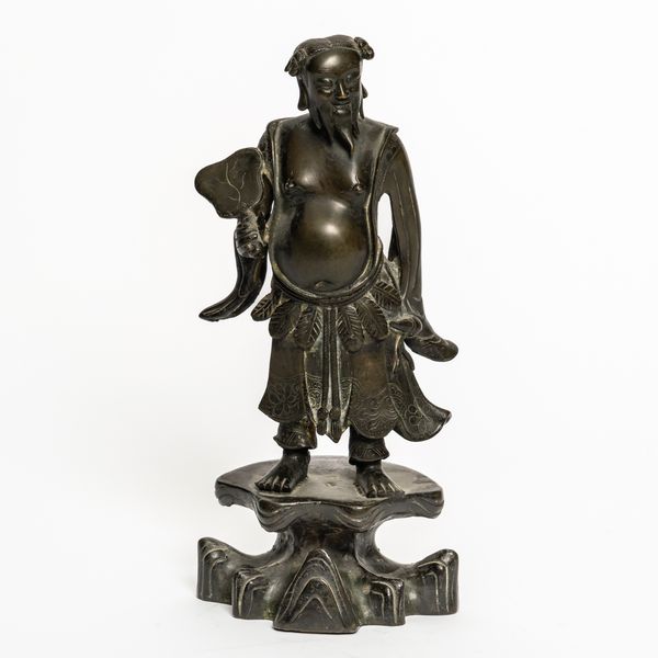 A CHINESE BRONZE STANDING FIGURE