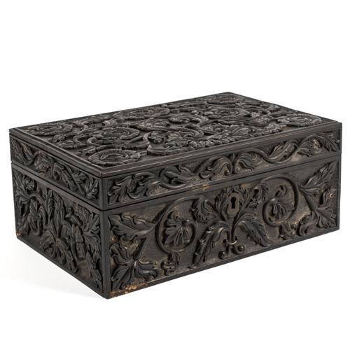 A CARVED EBONISED BOX