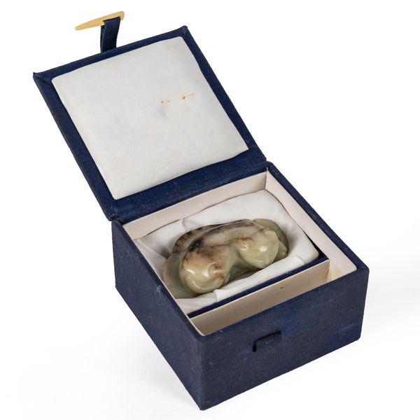 A CHINESE CELADON AND BROWN JADE 'CAT' CARVING (2)