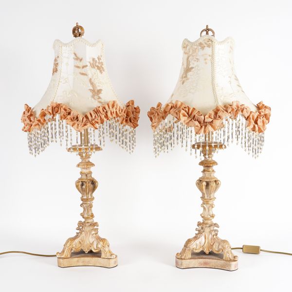 A PAIR OF 18TH CENTURY STYLE GILT PAINTED TABLE LAMPS WITH CARVED DECORATION