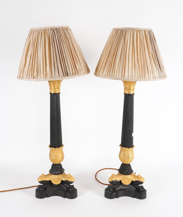 A PAIR OF EMPIRE STYLE BRONZE AND GILT METAL TABLE LAMPS OF COLUMN FORM