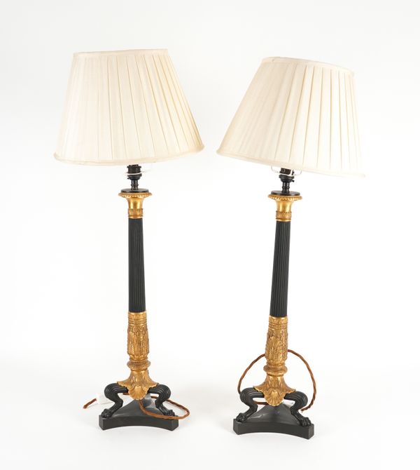 A PAIR OF EMPIRE STYLE BRONZE AND GILT METAL TABLE LAMPS OF COLUMN FORM WITH ACANTHUS MOULDED DECORATION