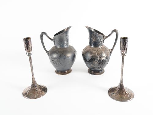 A PAIR OF PEWTER RELIEF CAST EWERS (5)
