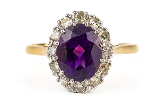 A GOLD, PLATINUM, AMETHYST AND DIAMOND OVAL CLUSTER RING