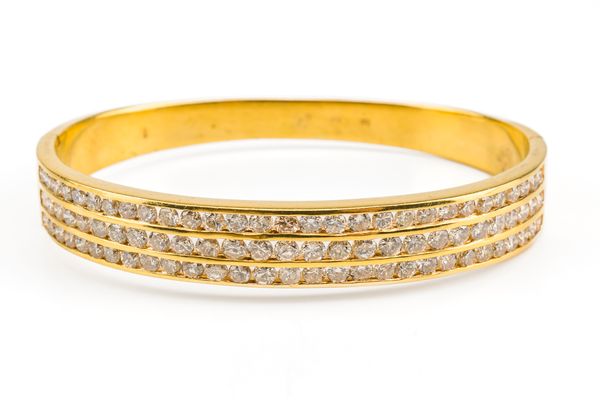 A GOLD AND DIAMOND OVAL HINGED BANGLE