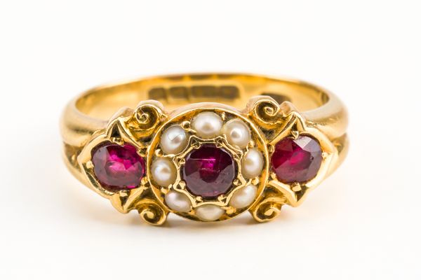 AN 18CT GOLD, RUBY AND HALF PEARL RING