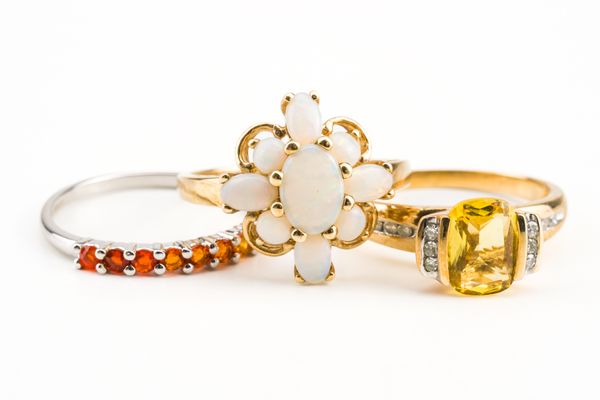 A 9CT GOLD AND OPAL NINE STONE CLUSTER RING AND TWO FURTHER RINGS (3)