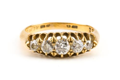 A GOLD AND DIAMOND FIVE STONE RING