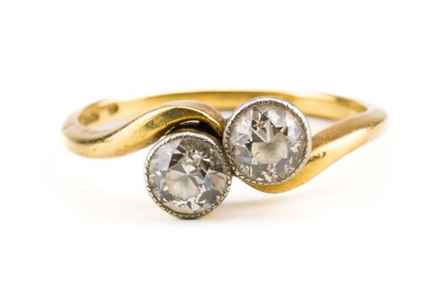 A GOLD AND DIAMOND TWO STONE RING