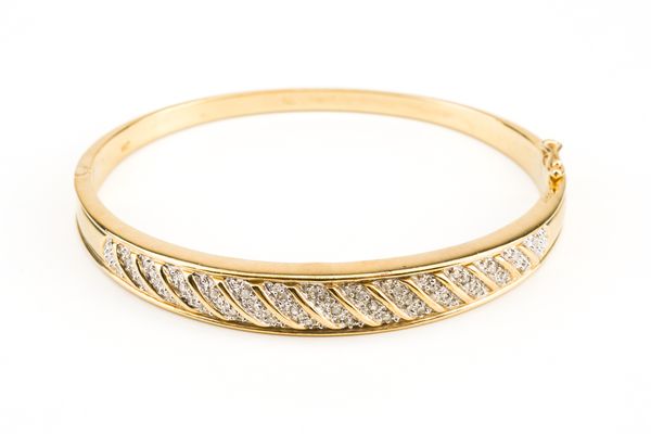 A 9CT GOLD AND DIAMOND SET BANGLE