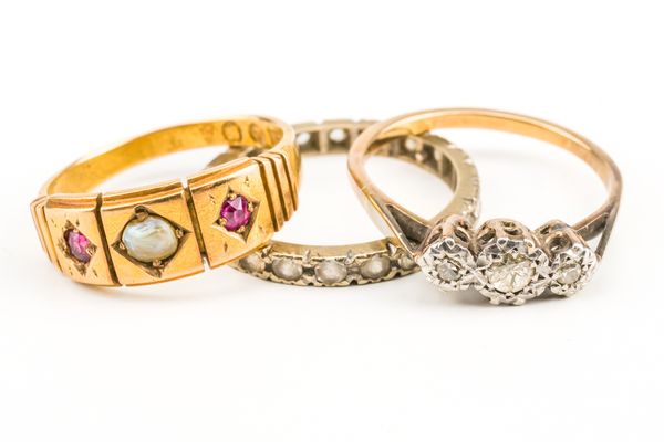 A VICTORIAN 15CT GOLD, RUBY AND HALF PEARL THREE STONE RING AND TWO FURTHER RINGS (3)