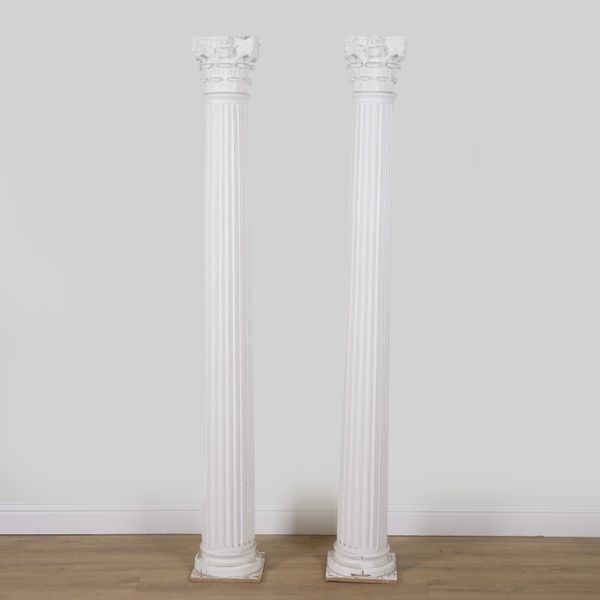 A PAIR OF WHITE PAINTED PLASTER FLOORSTANDING CORINTHIAN COLUMNS (2)