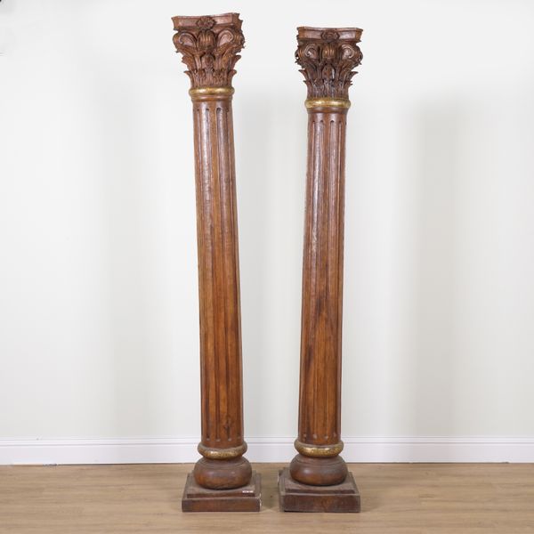 A NEAR PAIR OF 20TH CENTURY PARCEL GILT CARVED HARDWOOD CORINTHIAN COLLUMNS (2)