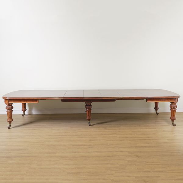 A LARGE VICTORIAN MAHOGANY EXTENDING DINING TABLE