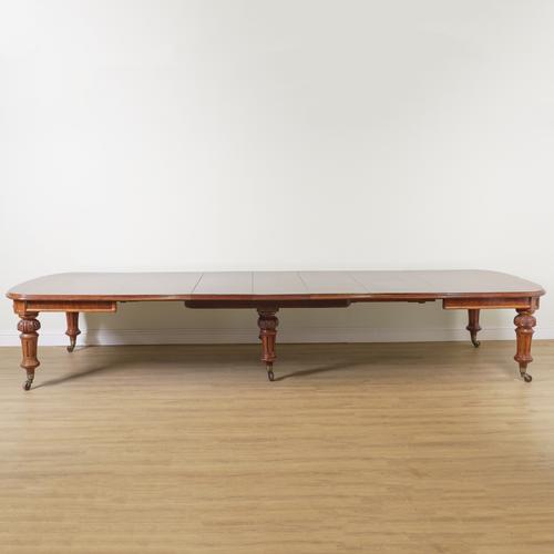 A LARGE VICTORIAN MAHOGANY EXTENDING DINING TABLE