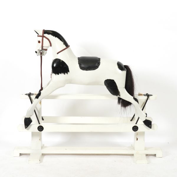 A PAINTED PIEBALD ROCKING HORSE