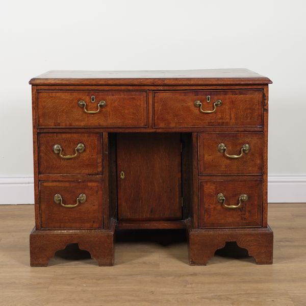 A GEORGE III OAK KNEEHOLE WRITING DESK