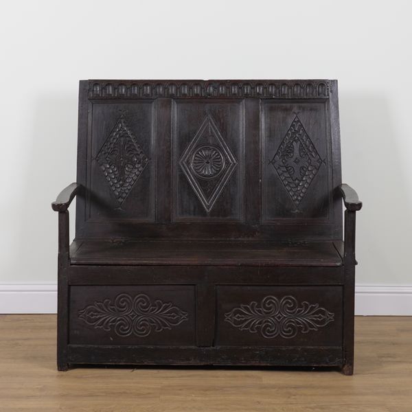 A CARVED OAK TRIPLE PANEL BACK BOX SEAT OPEN ARM SETTLE