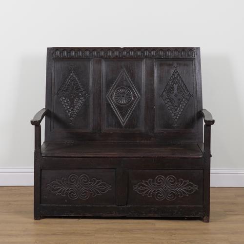 A CARVED OAK TRIPLE PANEL BACK BOX SEAT OPEN ARM SETTLE