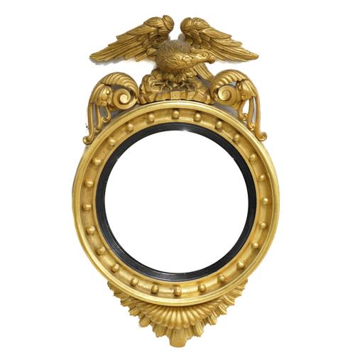 A REGENCY GILT FRAMED CONVEX WALL MIRROR